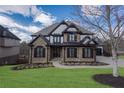 Charming two-story home featuring stone facade and manicured front lawn and inviting curb appeal at 2077 Towne Mill Ave, Canton, GA 30114