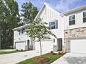A charming townhouse boasts a well-manicured lawn and a two-car garage at 4651 Larkfield Way, Powder Springs, GA 30127