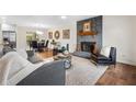 Spacious living room featuring a stone fireplace, hardwood floors and modern decor at 7316 Caribou Trl, Riverdale, GA 30296