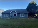 A view of the back of the house with a covered carport and an expansive lawn at 1007 Billy Mcgee Rd, Lawrenceville, GA 30045
