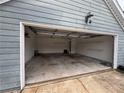 Spacious two-car garage with an open door and clean concrete floor at 1007 Billy Mcgee Rd, Lawrenceville, GA 30045