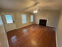Inviting living room with hardwood floors, fireplace, ceiling fan, and ample natural light at 1007 Billy Mcgee Rd, Lawrenceville, GA 30045