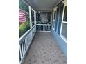 Inviting covered porch with decorative tile flooring, white railings, and natural light at 1007 Billy Mcgee Rd, Lawrenceville, GA 30045