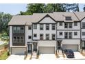 New townhouse exterior with white brick, garage, black trim, and professionally landscaped walkway at 1312 Stanley Park Dr, Decatur, GA 30033