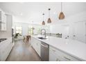 Bright, white kitchen with stainless appliances, quartz countertop, and modern lighting fixtures at 1312 Stanley Park Dr, Decatur, GA 30033