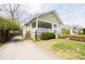 View of a light green home showcasing a covered porch and manicured shrubbery at 338 Clifford Ne Ave, Atlanta, GA 30317