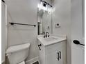 Well-lit bathroom featuring a vanity with a sink, modern fixtures, and a toilet at 2461 Sycamore Nw Rd, Atlanta, GA 30318
