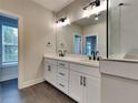 Modern bathroom featuring a double sink vanity, sleek fixtures, and a glass enclosed shower at 2461 Sycamore Nw Rd, Atlanta, GA 30318
