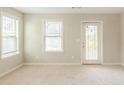 Bright bedroom with neutral carpet, a door to the outside, and natural light from two windows at 2819 Hillside Way, Decatur, GA 30034