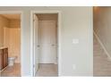 Hallway showing access to bathroom and staircase, with neutral color walls and flooring at 2819 Hillside Way, Decatur, GA 30034