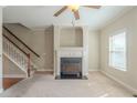 Cozy living room with a fireplace, window views, and staircase at 2819 Hillside Way, Decatur, GA 30034