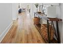 Inviting hallway with hardwood flooring, console table, and stylish decor, leading into the home at 514 Cunninghame Ct, Peachtree City, GA 30269