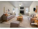 Bright, staged living room with a stone fireplace and comfortable seating area at 5281 Brookshire Ct, Douglasville, GA 30135