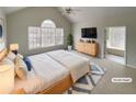 Staged main bedroom featuring vaulted ceilings, a cozy rug, and ensuite bathroom access at 5281 Brookshire Ct, Douglasville, GA 30135