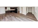 Open-concept view of living room, dining area and kitchen featuring sleek hardwood floors and neutral paint at 16 Wadley Nw St, Atlanta, GA 30314