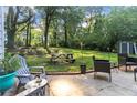 Spacious backyard featuring a concrete patio and an ample grassy lawn with a picnic table at 1824 Evans Sw Dr, Atlanta, GA 30310