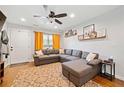 Cozy living room with a comfortable sectional sofa, decorative shelves, and a stylish rug, creating a welcoming atmosphere at 1824 Evans Sw Dr, Atlanta, GA 30310
