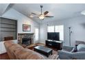 Comfortable living room with ceiling fan, stone fireplace, and ample natural light at 3225 Long Iron Dr, Lawrenceville, GA 30044
