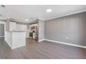 Open concept living room area with stainless steel appliances, and white cabinets at 504 Mill Pond Ct, Smyrna, GA 30082