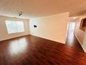 Living room featuring wood floors, white walls, and bright natural light from windows at 2204 Waldrop Pl, Decatur, GA 30034