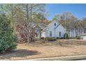 Charming single Gathering home with a stone-accented facade, mature trees, and a well-manicured lawn at 3619 Elinburg Ne Ct, Buford, GA 30519
