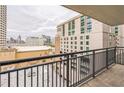 Condo balcony featuring black metal railing and scenic city views on a cloudy day at 620 Peachtree Ne St # 1413, Atlanta, GA 30308