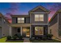 Charming two-story home with stone accents and well-maintained landscaping at dusk at 847 Venture Sw Way, Atlanta, GA 30331