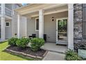 Inviting front porch with seating area, framed by elegant columns and lush landscaping for added curb appeal at 847 Venture Sw Way, Atlanta, GA 30331