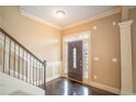 Elegant foyer with hardwood floors, detailed trim, stairs and natural light at 1137 Fortress Sw Ave, Atlanta, GA 30315