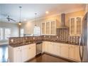Modern kitchen featuring stainless steel appliances, granite countertops, and stylish backsplash at 1137 Fortress Sw Ave, Atlanta, GA 30315