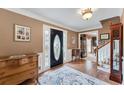 Traditional foyer with a decorative rug, beautiful hardwood floors, and a leaded glass front door at 2205 Parliament Dr, Lawrenceville, GA 30043