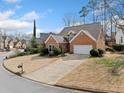 Attractive brick house with a well-maintained lawn, long driveway, and lush landscaping at 2692 Glenrose Hl, Atlanta, GA 30341