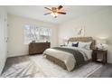 Bright bedroom with a ceiling fan, carpeted floors, and large window for natural light at 2232 Dunseath Nw Ave # 303, Atlanta, GA 30318