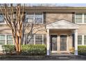 Charming townhome featuring a brick facade, black shutters, and covered entryway at 2232 Dunseath Nw Ave # 303, Atlanta, GA 30318