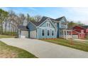 Beautiful blue home with attached garage and a well-maintained front lawn at 4041 Andover Cir, Mcdonough, GA 30252