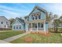 Attractive two-story home with a covered porch, stone walkway, and lush green lawn at 4041 Andover Cir, Mcdonough, GA 30252