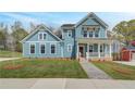 Inviting two-story home featuring a quaint front porch and professionally landscaped yard at 4041 Andover Cir, Mcdonough, GA 30252