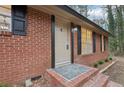 Close-up of front entry features brick steps, a stylish door, and a decorative exterior light at 6852 Old Beulah Rd, Lithia Springs, GA 30122