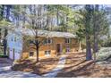 View of a two-story brick home with an attached garage and green shutters at 410 Killian Hill Sw Rd, Lilburn, GA 30047