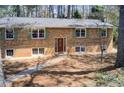 Traditional brick home with green shutters and a lovely landscaped yard at 410 Killian Hill Sw Rd, Lilburn, GA 30047