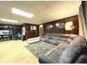Spacious living room with a large sectional couch, carpeted floor, and paneled walls at 4227 Cheryl Ann Court Ct, Stone Mountain, GA 30083