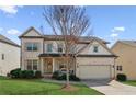 Charming two-story brick home with well-maintained landscaping, attached garage, and inviting front porch at 4270 Pleasant Woods Dr, Cumming, GA 30028