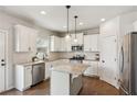 Modern kitchen with white cabinets, granite countertops, stainless steel appliances, and a convenient center island at 4270 Pleasant Woods Dr, Cumming, GA 30028