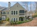 Back exterior view of condo with screened porch and staircase to raised porch at 500 Bainbridge Dr, Atlanta, GA 30327