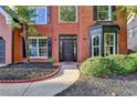 Inviting front entrance showcasing a stylish black door, neat landscaping, and a paved walkway, enhancing curb appeal at 1887 Lake Ridge Ter, Lawrenceville, GA 30043
