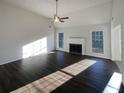 Sunlit living room featuring a fireplace, dark wood floors and neutral walls at 2979 Orchard Sw Rd, Conyers, GA 30094