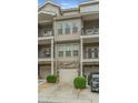 Townhome with private garage, balconies, and neutral facade for a modern living experience at 3066 Quantum Ln # 24, Atlanta, GA 30341