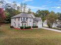 Charming two-story home featuring manicured landscaping and a spacious driveway at 3529 Riverview Approach, Ellenwood, GA 30294