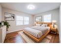 Cozy bedroom with hardwood floors, neutral walls, two windows, and a comfortable bed with stylish decor at 1251 Richland Sw Rd, Atlanta, GA 30310