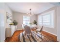 Bright dining room featuring a round table, stylish chairs, and a modern light fixture at 1251 Richland Sw Rd, Atlanta, GA 30310